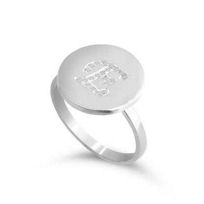 Silver ring with engraved letter 'E' on a white background