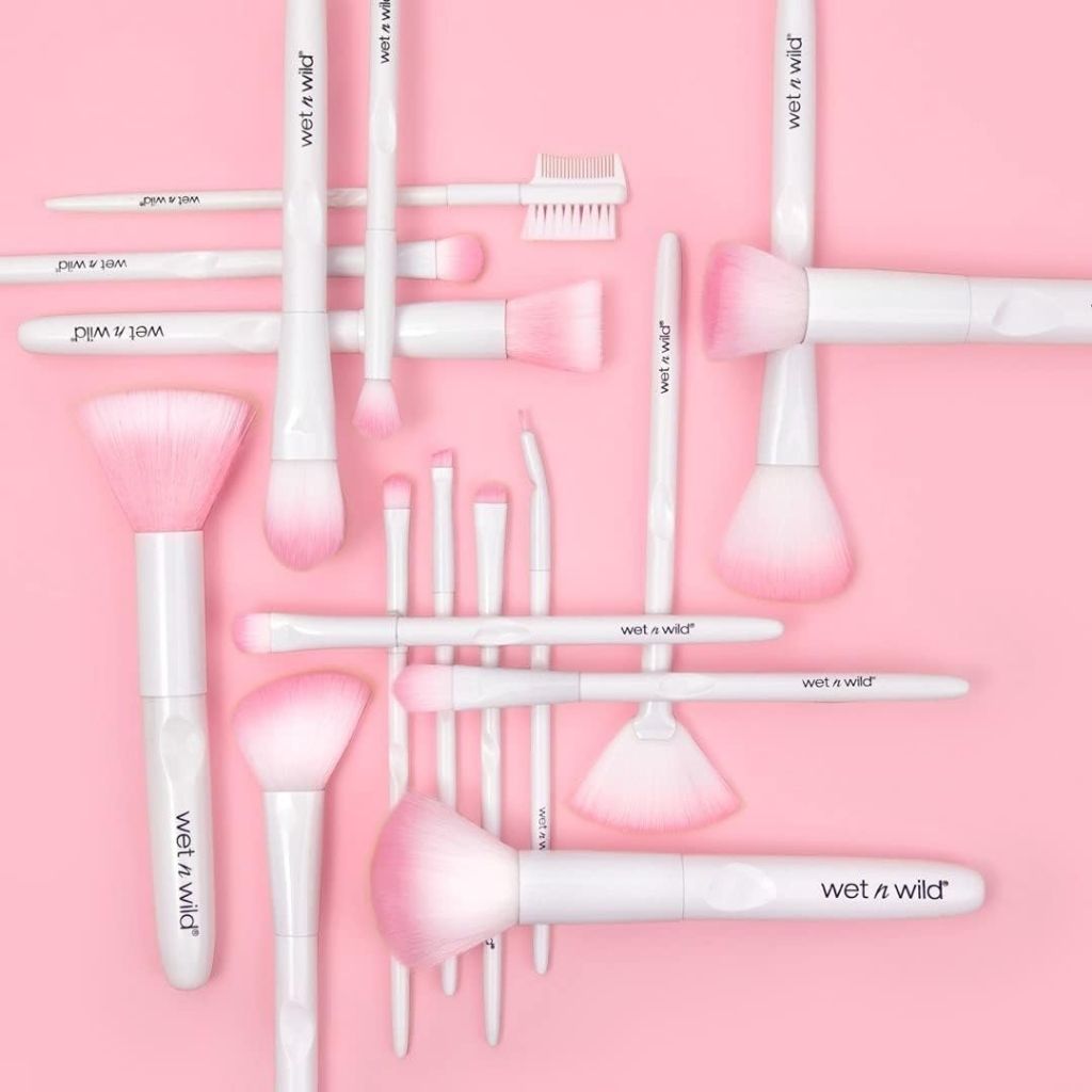 Collection of Wet n Wild makeup brushes on a pink background