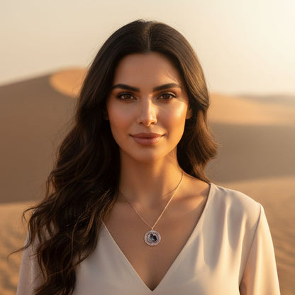 Woman with long dark hair and a necklace standing in a desert landscape