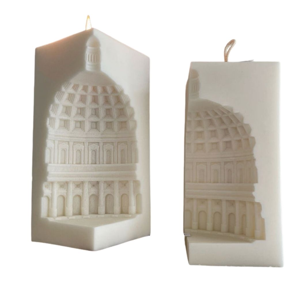 Two candles with architectural design on a white background