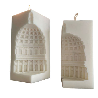 Two candles with architectural design on a white background