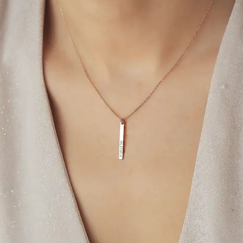 Necklace with a vertical bar pendant on a mannequin