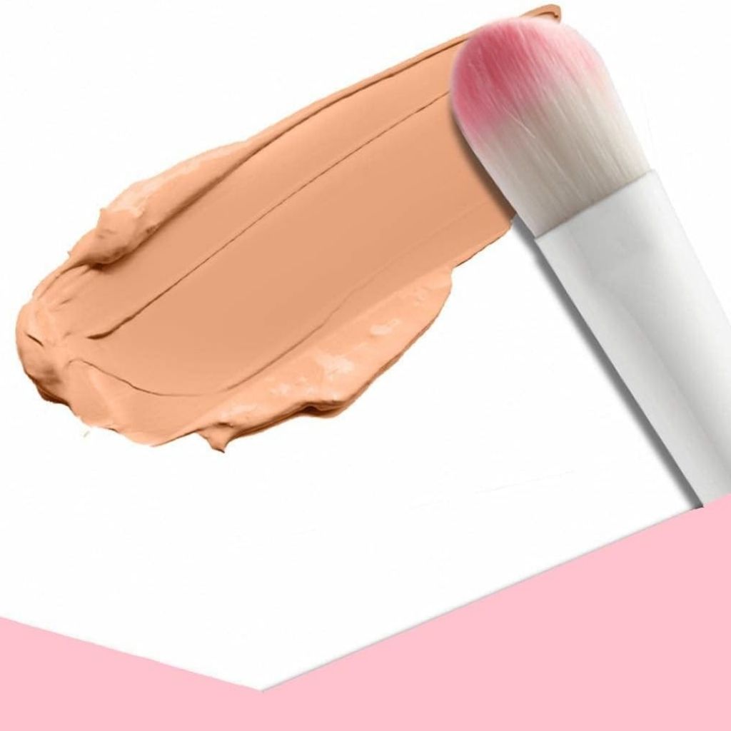 Makeup foundation with a brush on a white background