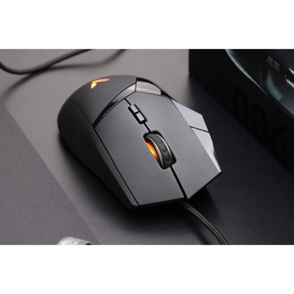 Black gaming mouse with orange accents on a desk