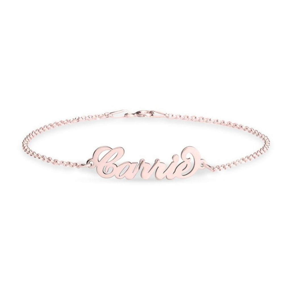 Rose gold bracelet with 'Carrie' engraving on a white background