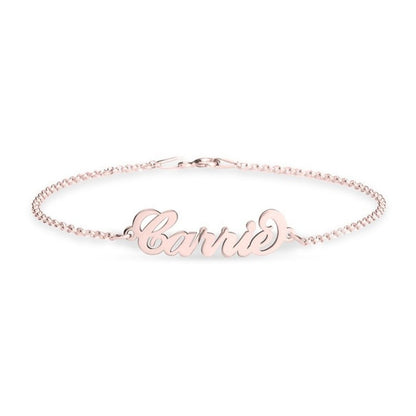 Rose gold bracelet with 'Carrie' engraving on a white background