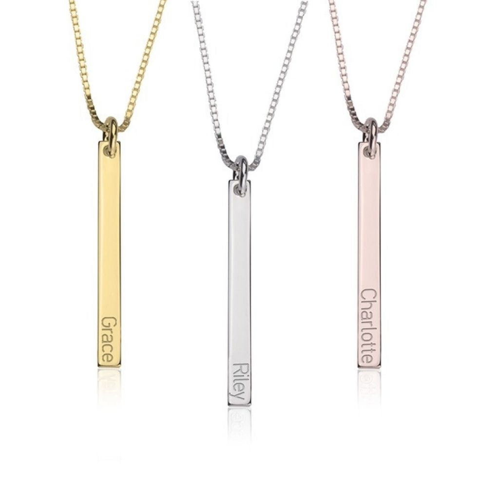 Three vertical bar necklaces in gold, silver, and rose gold on a white background.