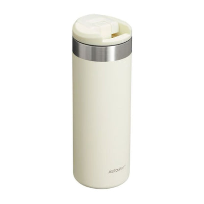 Cream-colored thermos with silver lid on a white background