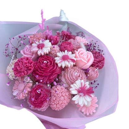 Bouquet of pink and white flowers wrapped in pink paper on a white background