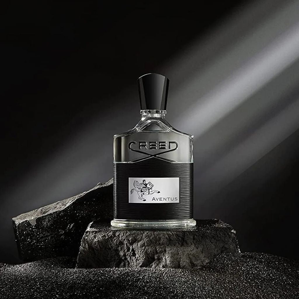 Creed Aventus perfume bottle on a dark background