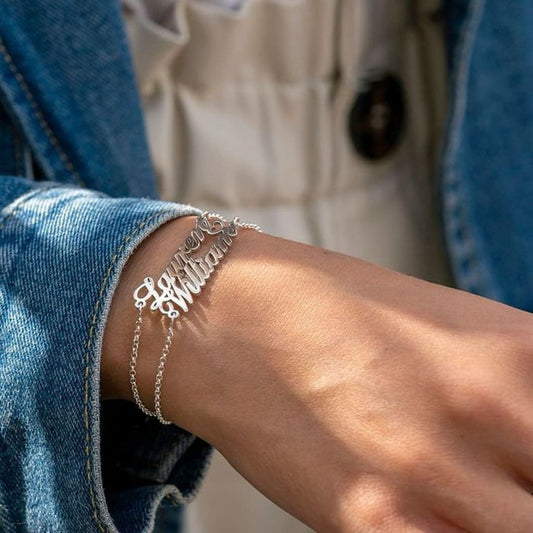 Silver bracelet on a person's wrist with a blurred background