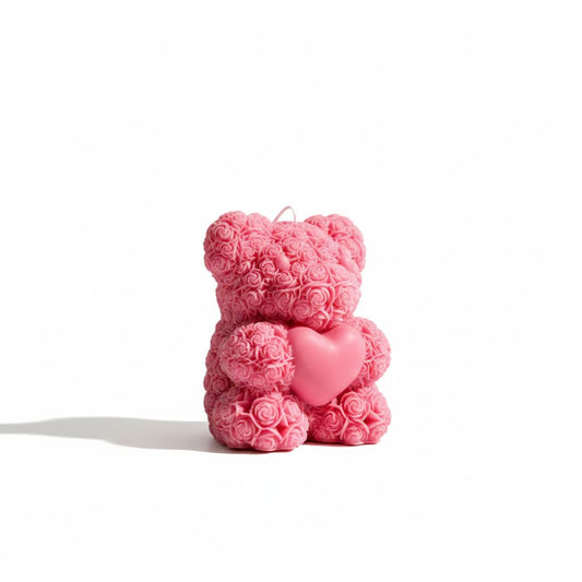 Pink teddy bear made of roses with a heart on a white background