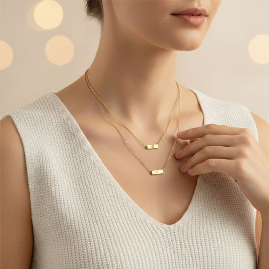 Woman wearing a gold necklace with a soft focus background
