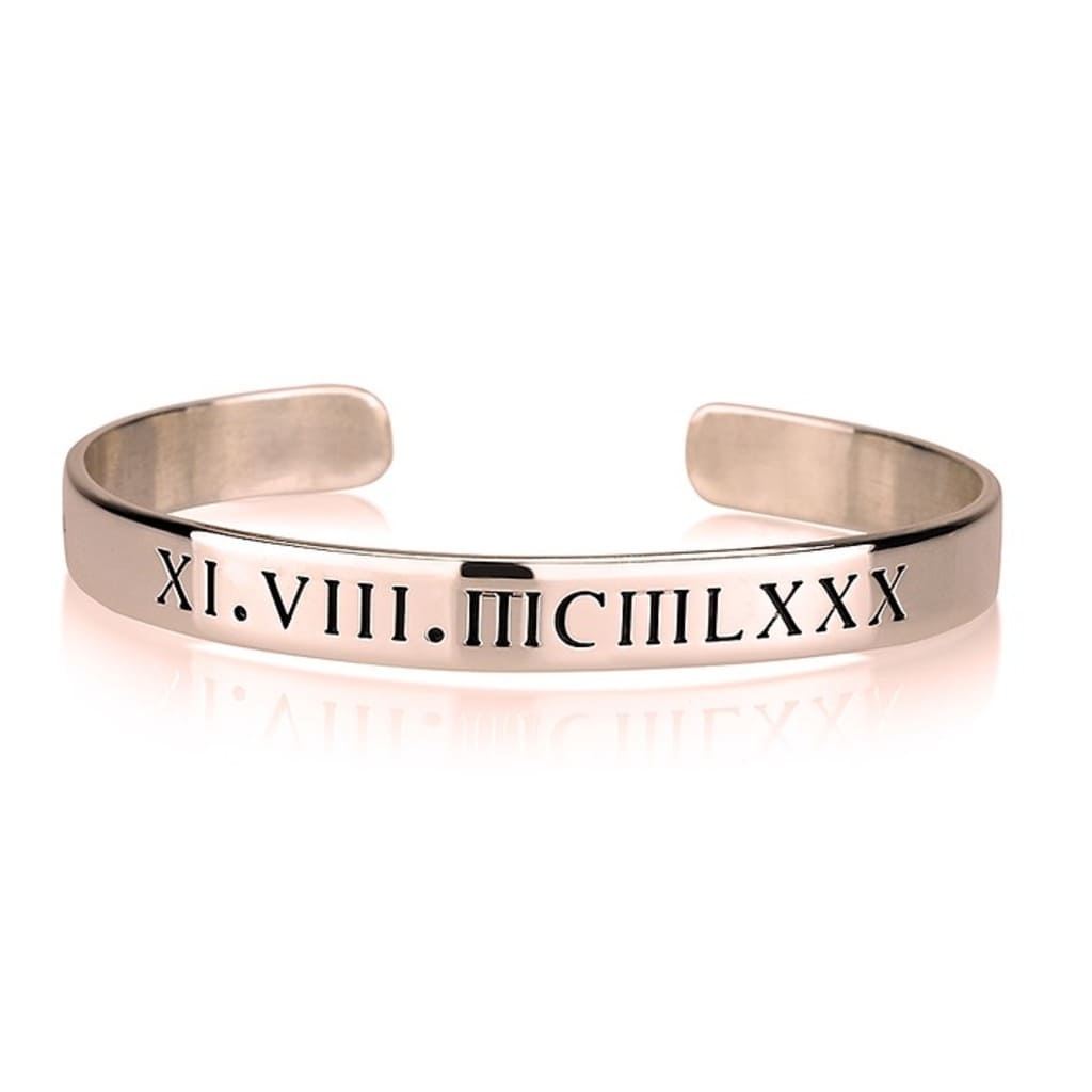 Rose gold bracelet with Roman numeral engraving on a white background