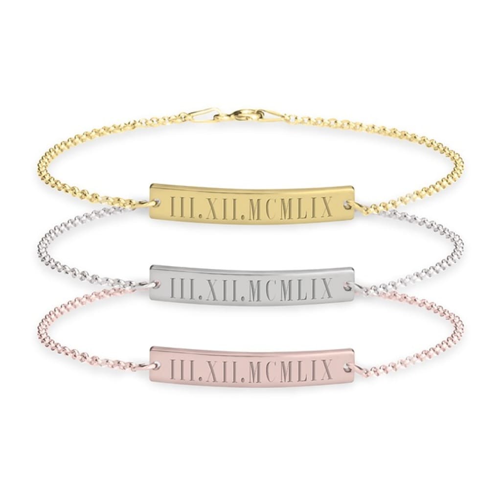 Three gold, silver, and rose gold bracelets with Roman numeral engraving on a white background