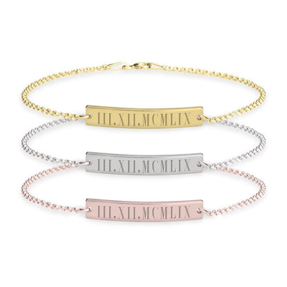 Three gold, silver, and rose gold bracelets with Roman numeral engraving on a white background