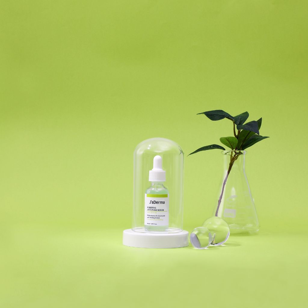 Skincare bottle with dropper on a green background