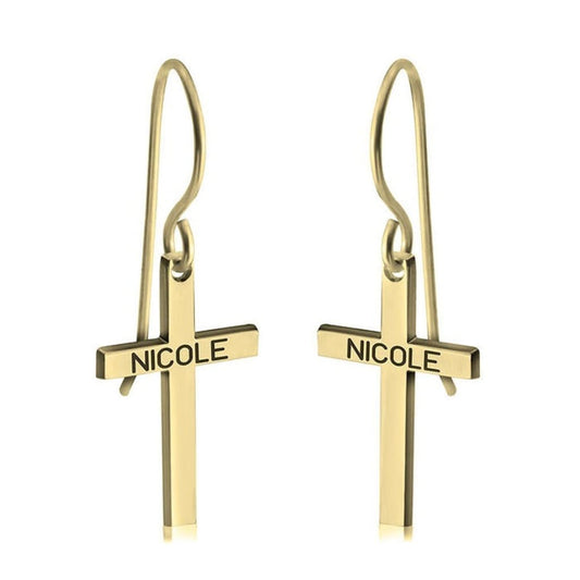 Gold cross-shaped earrings with 'NICOLE' engraving on a white background