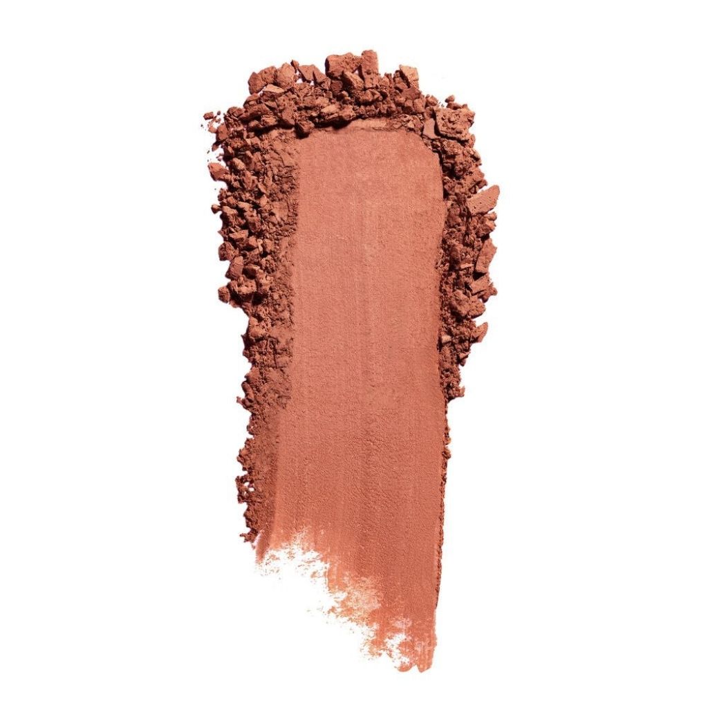 Peach-colored makeup powder swatch on a white background