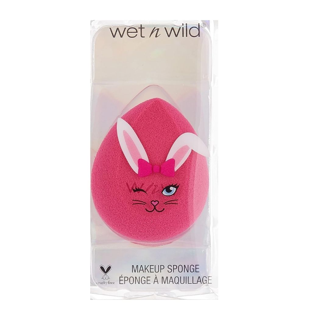 Pink makeup sponge with bunny ears and a bow in packaging on a white background