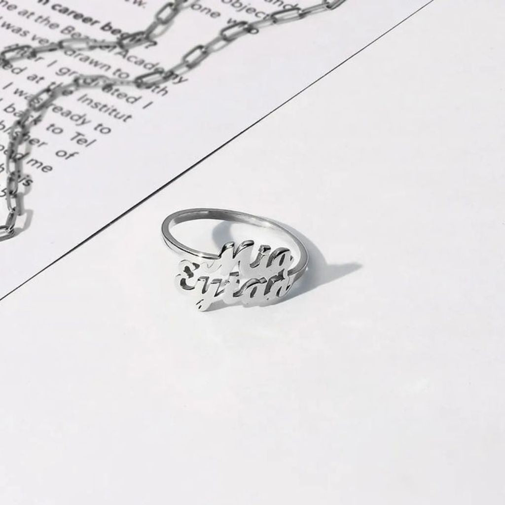 Silver ring and necklace on a piece of paper