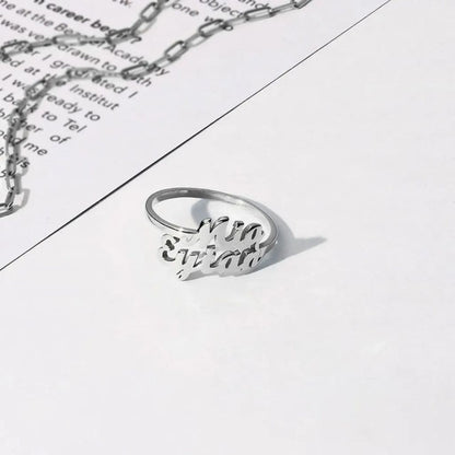 Silver ring and necklace on a piece of paper