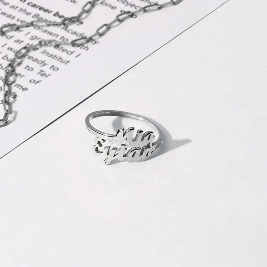 Silver ring and necklace on a piece of paper