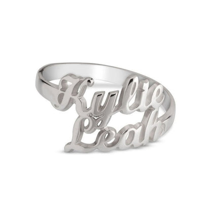 Silver ring with cut-out letters spelling 'Kylee Leah' on a white background