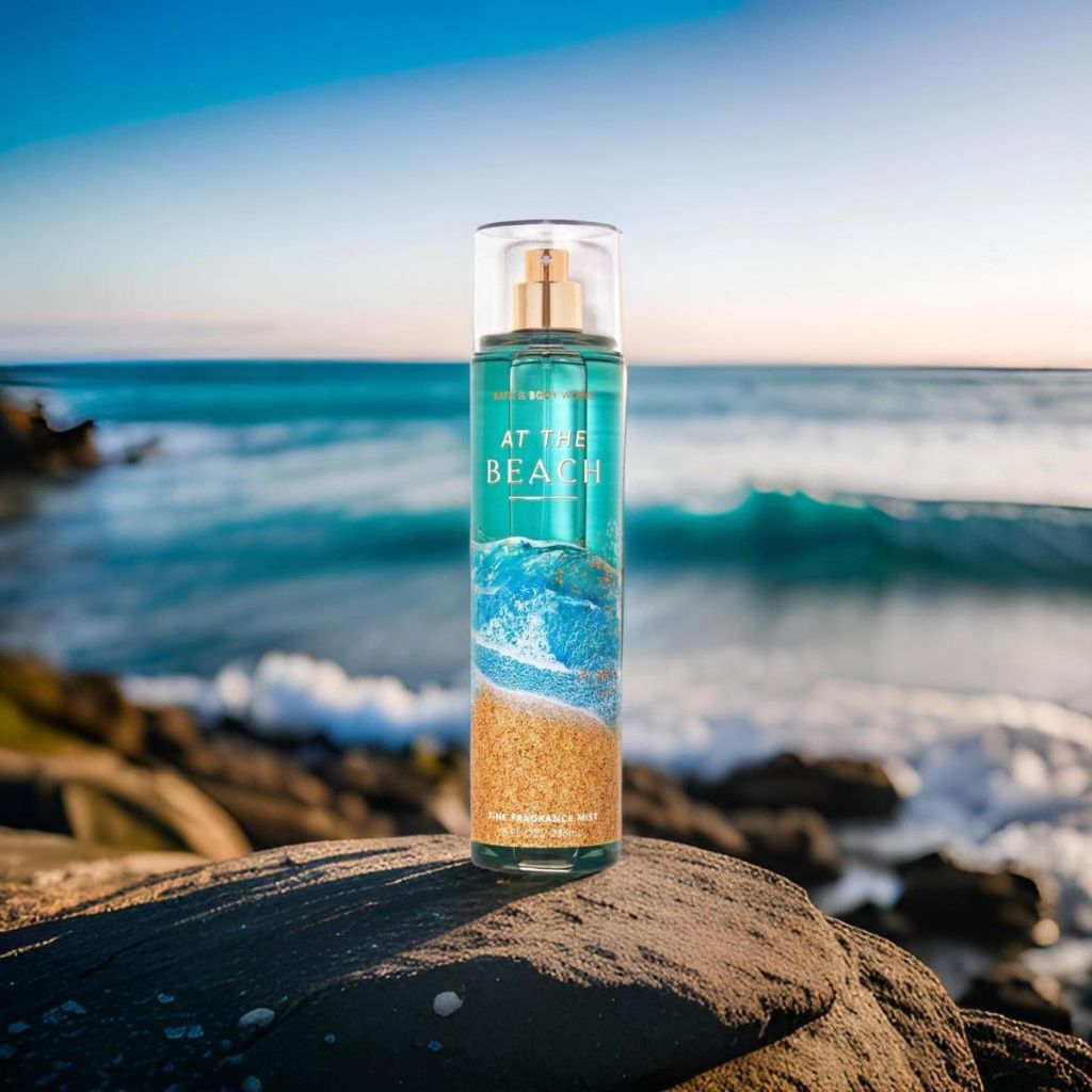 Bottle of 'At the Beach' body spray on a rock with ocean view