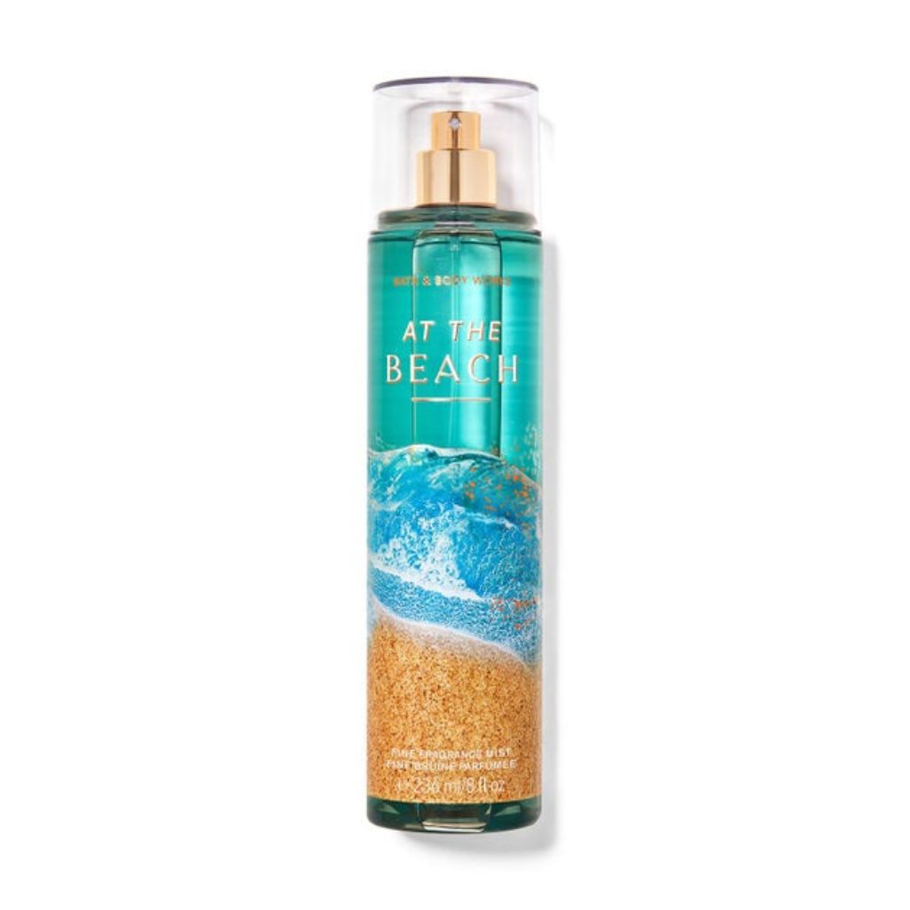Bottle of 'At the Beach' body spray with a beach-themed design on a white background