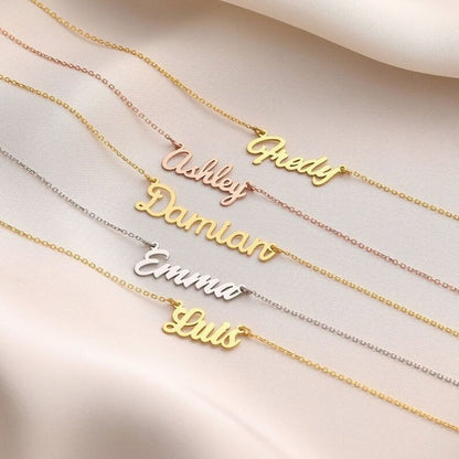 Gold and silver name necklaces on a light background