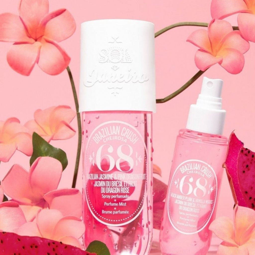 Two Brazilian Crush perfume bottles on a pink floral background