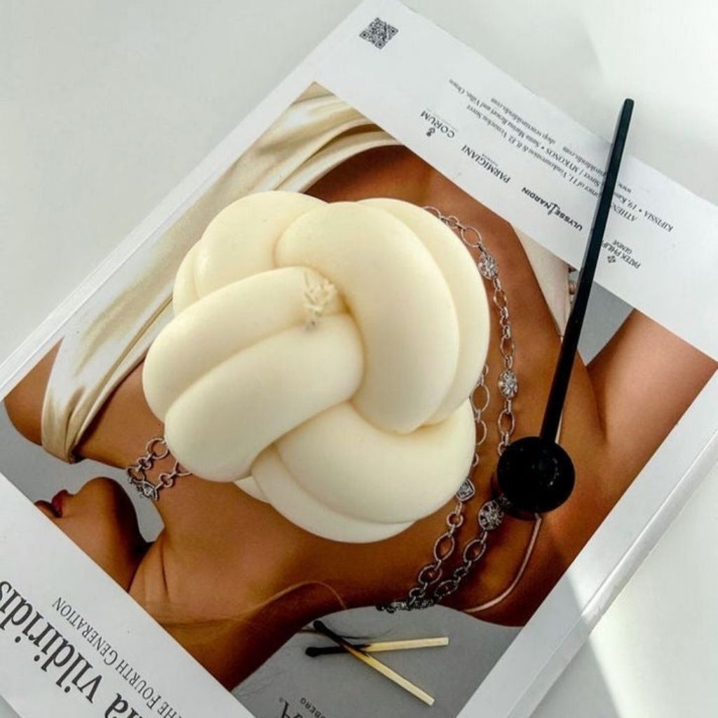 White hair bun accessory on a magazine with visible text