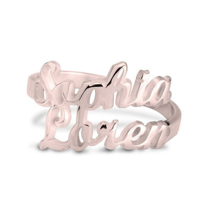 Rose gold ring with 'Sophia Loren' engraving on a white background