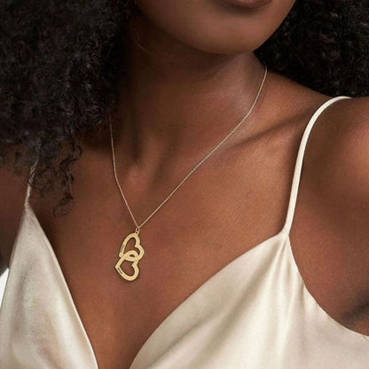 Woman wearing a gold necklace with a heart pendant