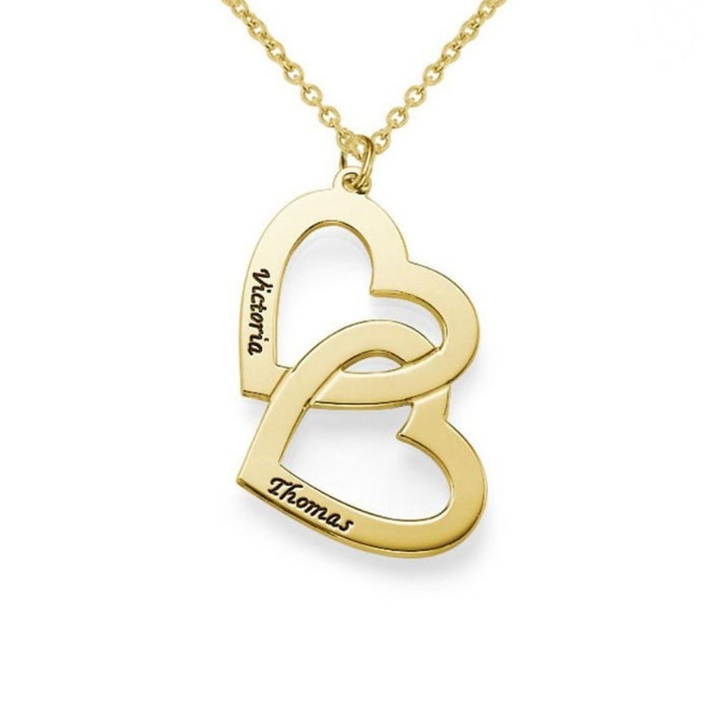 Gold heart-shaped pendant necklace with engraved names on a white background