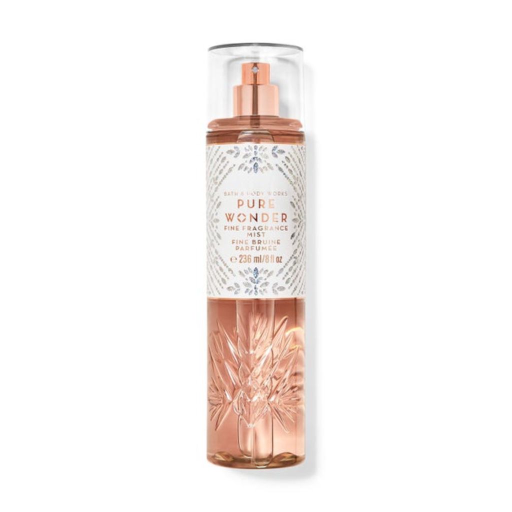 Rose gold mist spray bottle with decorative label on a white background