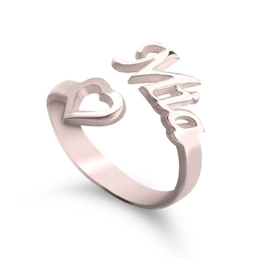Rose gold ring with heart and 'LOVE' design on a white background