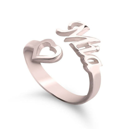 Rose gold ring with heart and 'LOVE' design on a white background