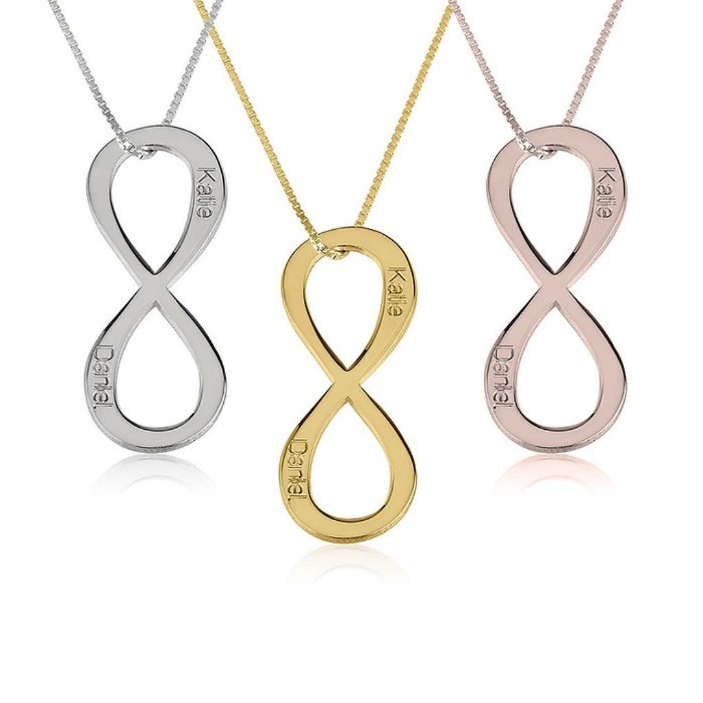 Three infinity symbol necklaces in silver, gold, and rose gold on a white background.