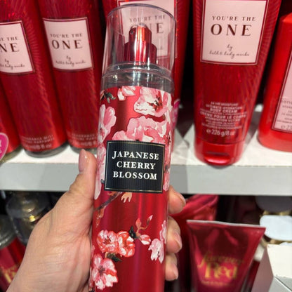 Hand holding a red floral product labeled 'Japanese Cherry Blossom' with similar products in the background.
