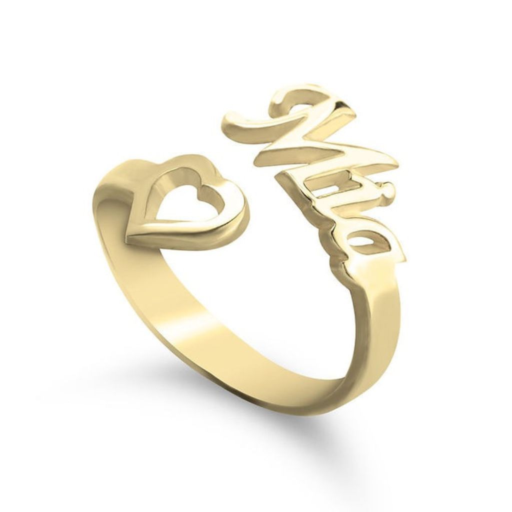 Gold ring with a heart design and Chinese character on a white background