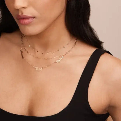 Woman wearing a gold necklace with a plain background