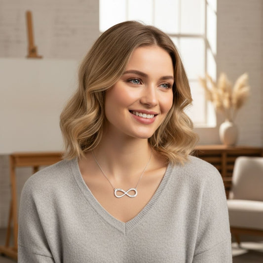 Woman wearing an infinity necklace in a bright room