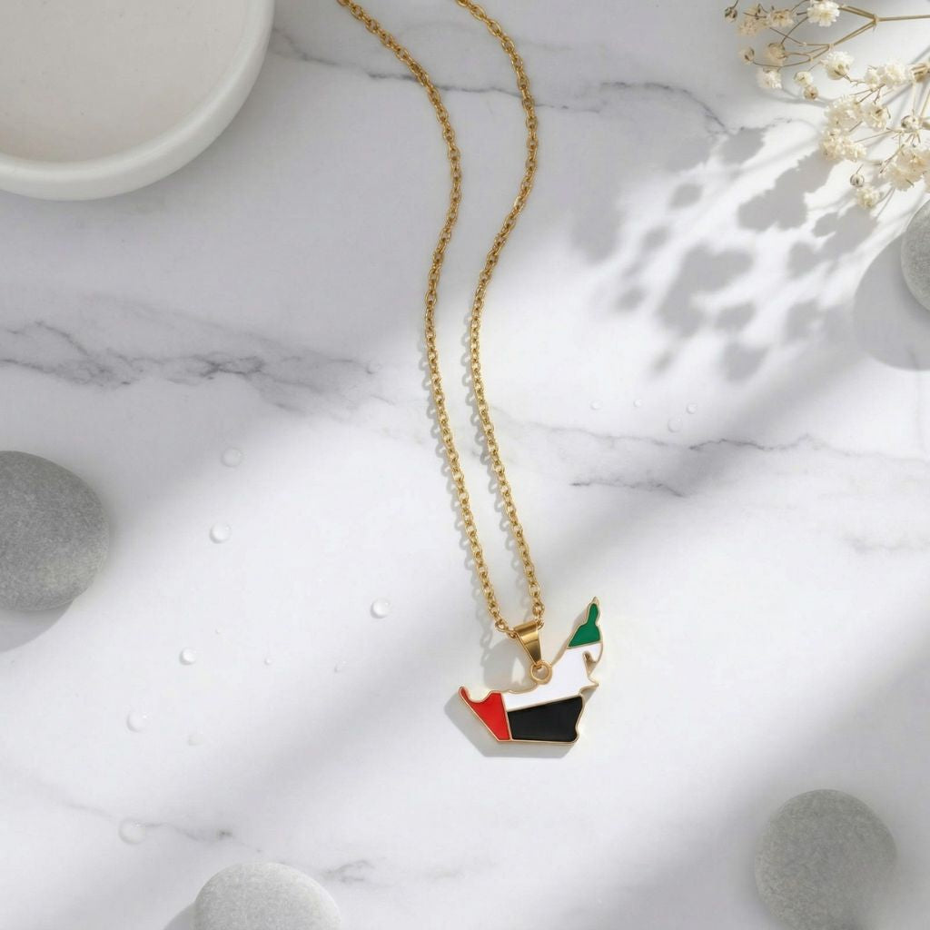 Gold necklace with a colorful pendant on a marble surface
