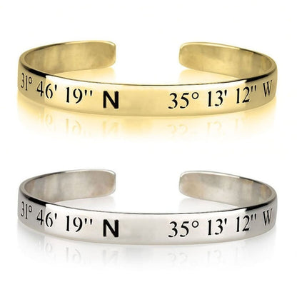 Gold and silver cuff bracelets with engraved coordinates on a white background
