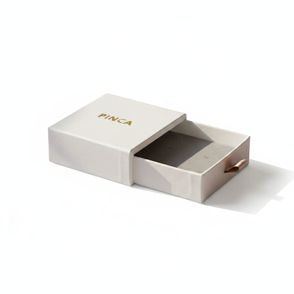 Open beige box with 'PINCA' branding on a white background