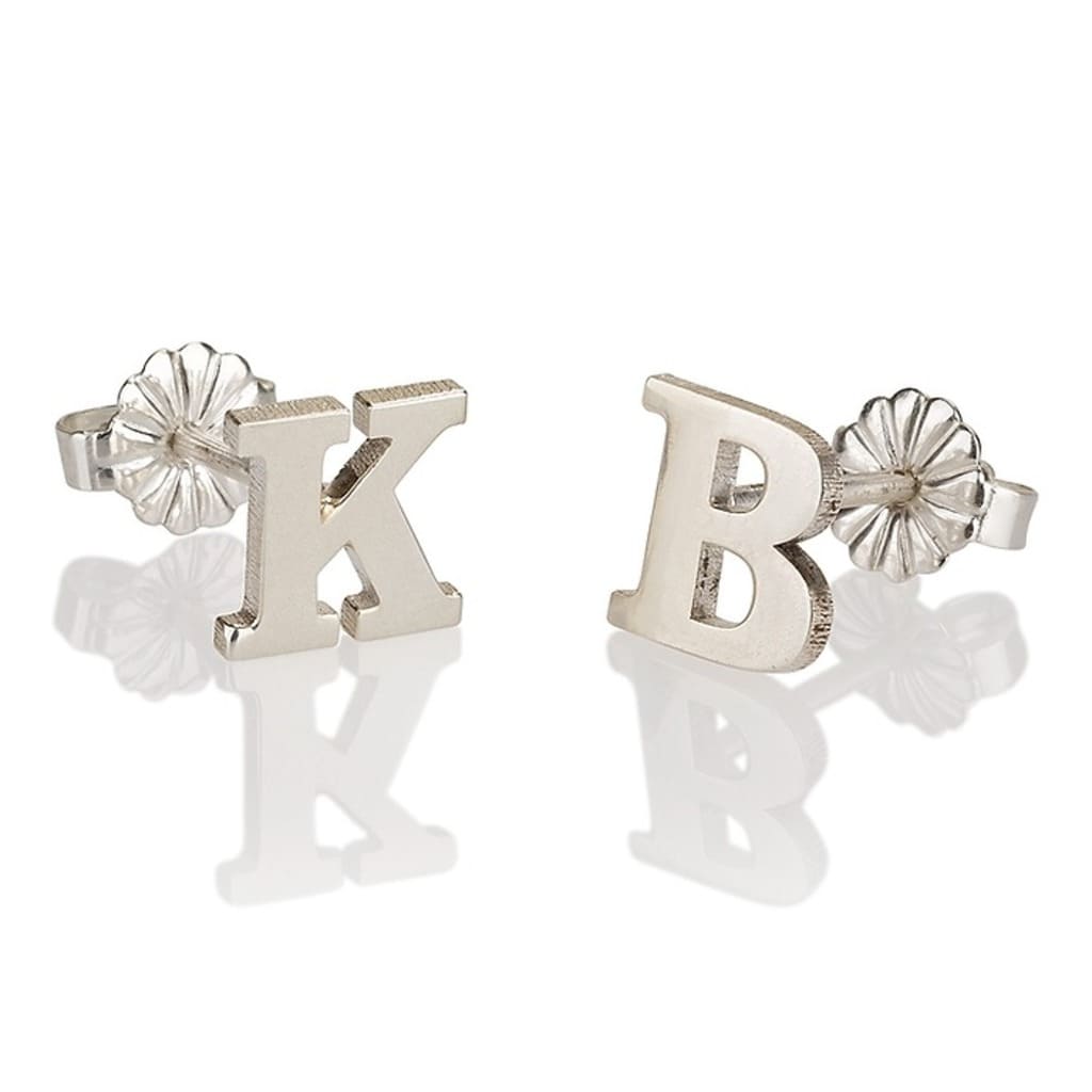 Silver letter 'K' and 'B' stud earrings on a white background