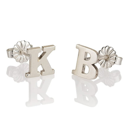 Silver letter 'K' and 'B' stud earrings on a white background