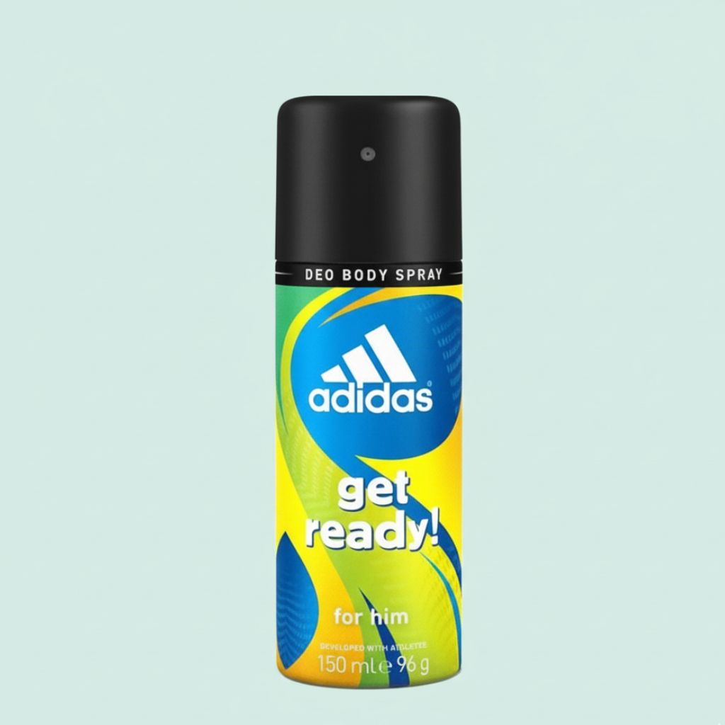 Adidas deodorant spray bottle on a light blue background